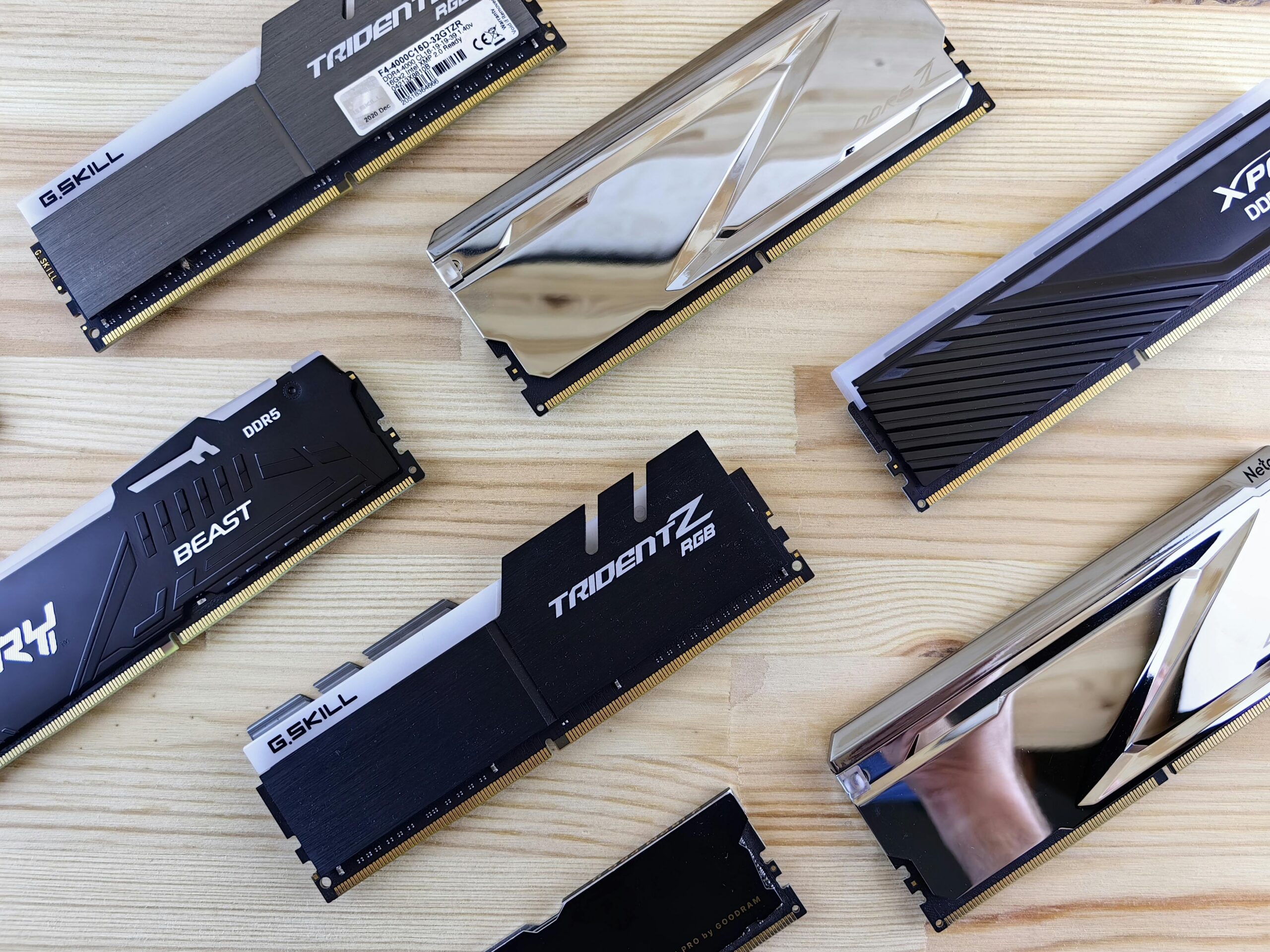 Top view of modern computer RAM sticks arranged on a wooden surface for technology enthusiasts.