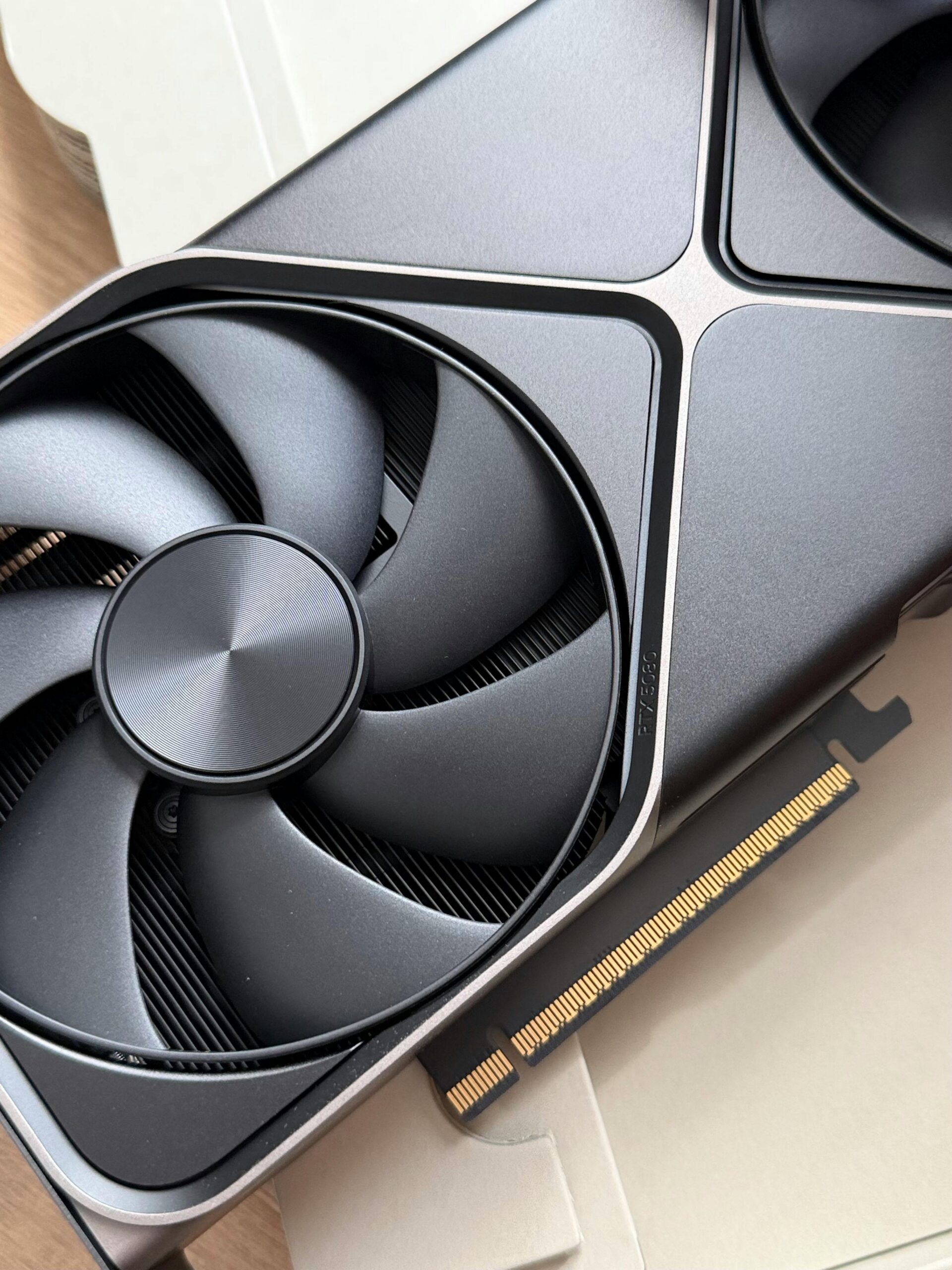 Close-up of a high-performance graphics card with detailed cooling fan design, ideal for tech enthusiasts.